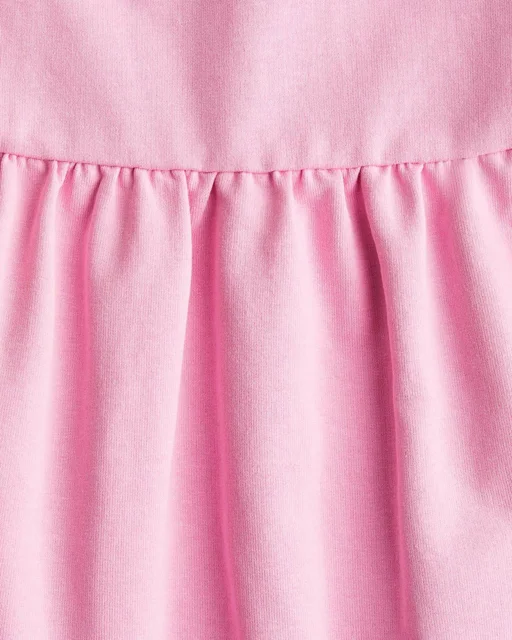 نمای نزدیک پیراهن دخترانه دورس صورتی طرح ساده h&m